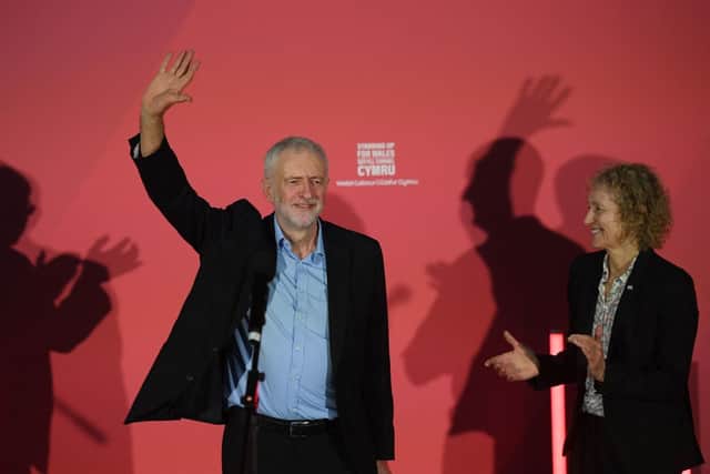 Jeremy Corbyn (L) waves on stage with Christina Rees (R), Labour candidate for Neath, as he campaigns for the general election in Swansea, south Wales on December 7, 2019 (Photo by DANIEL LEAL/AFP via Getty Images)