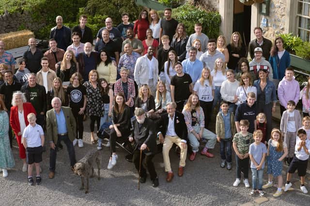 Emmerdale cast members old and new gather for a group photograph outside of The Woolpack pub (Photo: ITV)