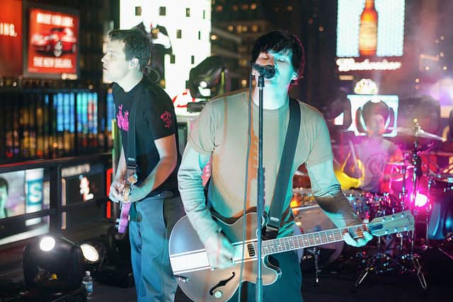 Blink 182 performs during “Spankin’ New Music Week” on MTV’s Total Request Live on a balcony outside at the MTV Times Square Studios November 11, 2003 in New York City.  (Photo by Scott Gries/Getty Images)