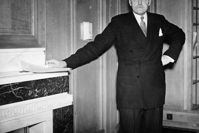 John Charles Walsham Reith in January 1940, during his time as Minister of Information, one hand resting on a mantelpiece (Credit:  William A. Atkins/Central Press/Getty Images)
