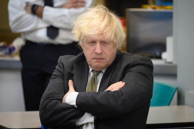 Boris Johnson speaks with members of the Metropolitan Police in their break room, as he makes a constituency visit to Uxbridge police station on December 17, 2021 in Uxbridge, England. (Photo by Leon Neal/Getty Images)
