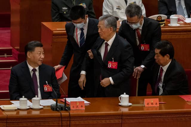 Former President Hu Jintao is helped to leave early from the closing session of the 20th National Congress of the Communist Party of China (Pic: Getty Images)