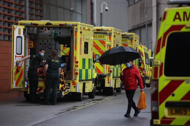 LONDON, ENGLAND - JANUARY 04: Paramedics take a patient from an ambulance into the Royal London Hospital on January 4, 2022 in London, England. By the New Year, nearly one in 10 NHS staff were off work with 50,000 at home either sick or self-isolating. (Photo by Dan Kitwood/Getty Images)
