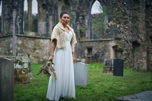 Mali Ann Rees as Megan in The Pact S2, stood in a graveyard, wearing a wedding dress (Credit: BBC/Little Door Productions/Simon Ridgway)