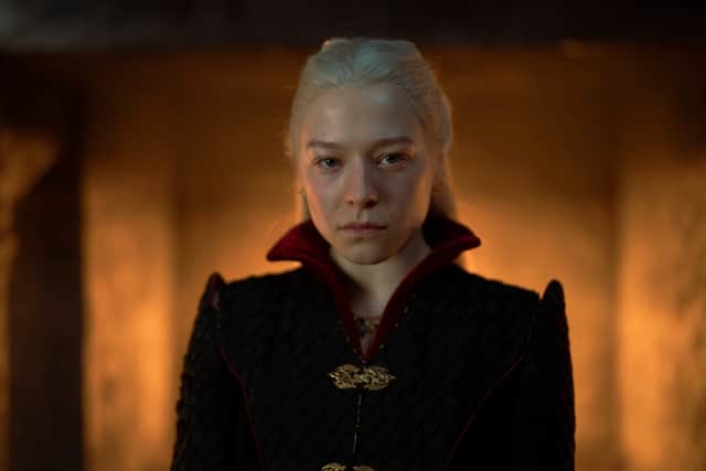 Emma D’Arcy as Queen Rhaenyra Targaryen, a hearth fire glowing behind her (Credit: HBO)