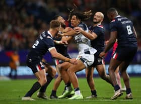 England’s Dom Young is tackled during group stage match against France