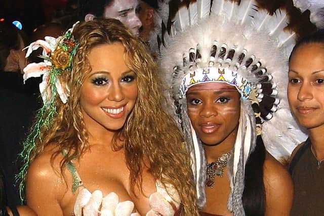 Pop star Mariah Carey (left) at a Halloween party in London in 2003 with a guest dressed as a Native American (Getty Images)