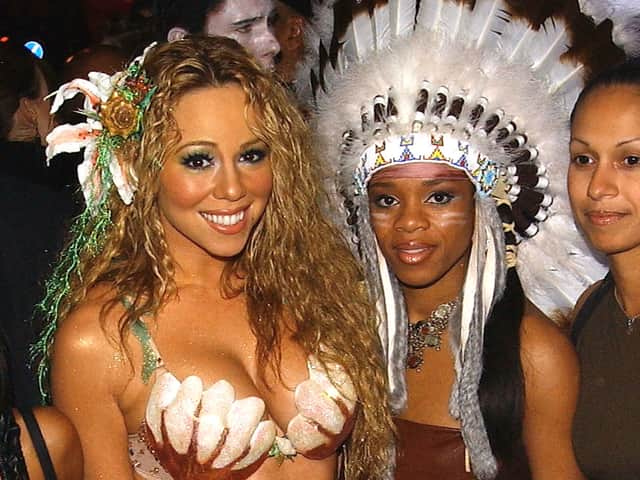 Pop star Mariah Carey (left) at a Halloween party in London in 2003 with a guest dressed as a Native American (Getty Images)