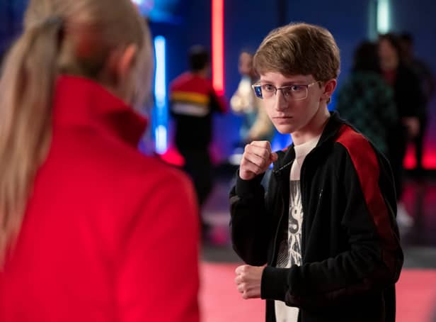 Owen Morgan as Bert in Cobra Kai, wearing thin glasses and doing a Karate stance (Credit: Curtis Bonds Baker/Netflix)