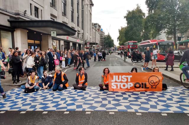 Just Stop Oil protesters block High Street Kensington in central London. Credit: Just Stop Oil