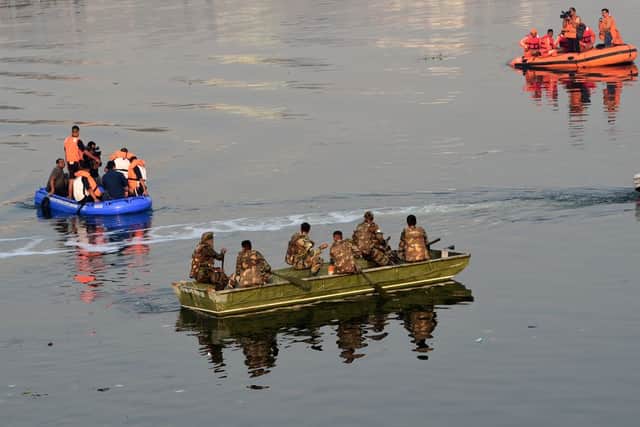 Emergency crews are now recovering the dead from the Machhu river (image: AFP/Getty Images)