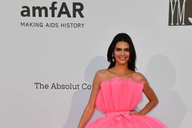 Kendall Jenner  in a hot pink Giambattista Valli Paris x H & M dress. (Photo by ALBERTO PIZZOLI/AFP via Getty Images)