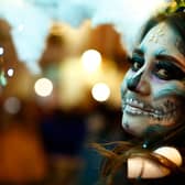 A woman dressed as a catrina participates during the parade of the “Day Of The Dead Festival” in Guanajuato, Mexico (Getty Images)