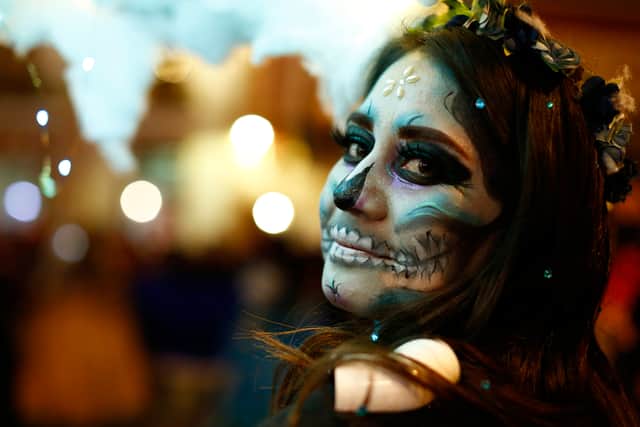 A woman dressed as a catrina participates during the parade of the “Day Of The Dead Festival” in Guanajuato, Mexico (Getty Images)