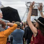 A family with a baby wearing ear defenders on his fathers shoulders watch Hacienda Classical on the Pyramid stage at Glastonbury Festival 2017 (Photo: Chris J Ratcliffe/Getty Images)