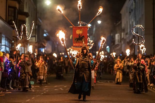 LEWES, ENGLAND - NOVEMBER 05: People take part in the parade at the annual Lewes Bonfire Night Celebrations on November 5, 2021 in Lewes, England. The event commemorates the memory of the seventeen Protestant martyrs as Bonfire Societies parade through the narrow streets. The evening comes to an end with the burning of effigies, or ‘guys’ usually representing Guy Fawkes, who died in 1605 after an unsuccessful attempt to blow up The Houses of Parliament, and other topical figures. The annual parade was cancelled last year due to the Covid-19 pandemic. (Photo by Dan Kitwood/Getty Images)
