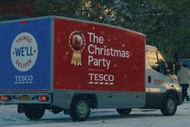 A Tesco Delivery Van, with the words ‘The Christmas Party’ and a mince pie in a ribbon emblazoned on the side (Credit: Tesco)