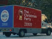 A Tesco Delivery Van, with the words ‘The Christmas Party’ and a mince pie in a ribbon emblazoned on the side (Credit: Tesco)