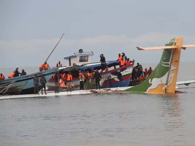 Rescuers search for survivors after a Precision Air flight that was carrying 43 people plunged into Lake Victoria as it attempted to land in the lakeside town of Bukoba, Tanzania on November 6, 2022. - Three people died when a plane carrying dozens of passengers plunged into Lake Victoria in Tanzania on November 6, 2022, as it approached the northwestern city of Bukoba, the fire and rescue service said. Rescuers have pulled 26 survivors to safety after the Precision Air plane crashed due to bad weather, with 43 people, including 39 passengers, aboard flight PW 494 from the financial capital Dar es Salaam to the lakeside city, according to regional authorities. (Photo by SITIDE PROTASE / AFP) (Photo by SITIDE PROTASE/AFP via Getty Images)