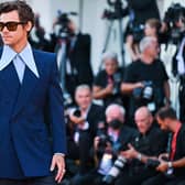 Harry Styles looking so stylish in a Gucci suit at the 2022 Venice Film Festival.   (Photo by TIZIANA FABI/AFP via Getty Images)