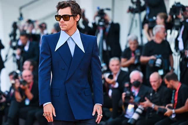 Harry Styles looking so stylish in a Gucci suit at the 2022 Venice Film Festival.   (Photo by TIZIANA FABI/AFP via Getty Images)