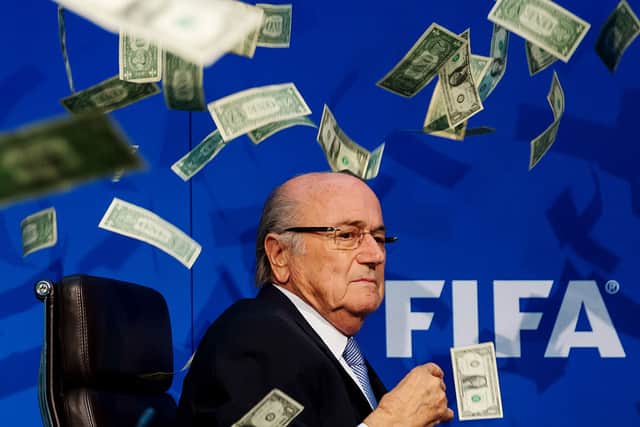 Comedian Simon Brodkin (not pictured) throws dollar bills at FIFA President Sepp Blatter during a press conference in 2015 (Photo: Philipp Schmidli/Getty Images)