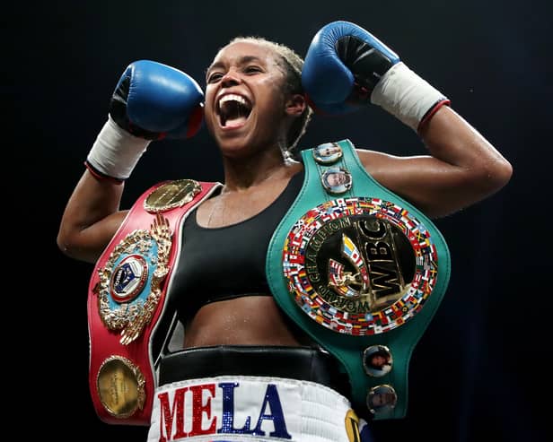 Jonas celebrates with her WBO and WBC belts in September 2022 