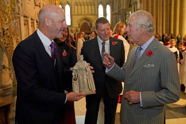 Britain’s King Charles is presented with a maquette of the statue of the statue of his late mother Queen Elizabeth II (Getty Images)
