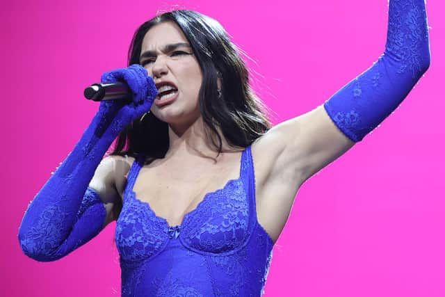 Dua Lipa wore a purple lace ensemble with matching gloves (Pic:Getty)