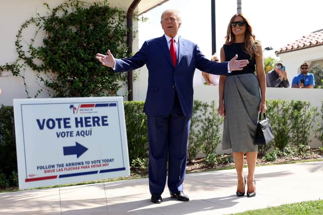 Former U.S. President Donald Trump stands with former first lady Melania Trump as he speaks to the media after voting at a polling station setup in the Morton and Barbara Mandel Recreation Center on November 08, 2022 in Palm Beach, Florida. After months of candidates campaigning, Americans are voting in the midterm elections to decide close races across the nation. (Photo by Joe Raedle/Getty Images)