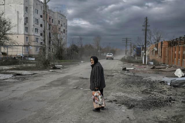 An old woman walks in the Kherson region village of Arkhanhelske on November 3, 2022, which was formerly occupied by Russian forces (AFP via Getty Images)