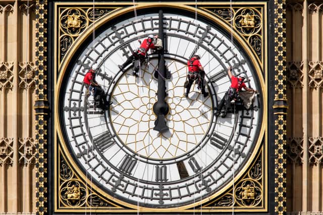 Workers clean one of the clock faces of the Elizabeth Tower. Credit: Getty Images