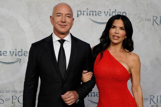 Amazon Founder and Executive Chair Jeff Bezos and Lauren Sanchez pose on the red carpet upon arrival to attend the Global Premiere of “The Lord of the Rings: The Rings of Power” at the Odeon cinema in Leicester Square, central London, on August 30, 2022. (Photo by NIKLAS HALLE’N/AFP via Getty Images)