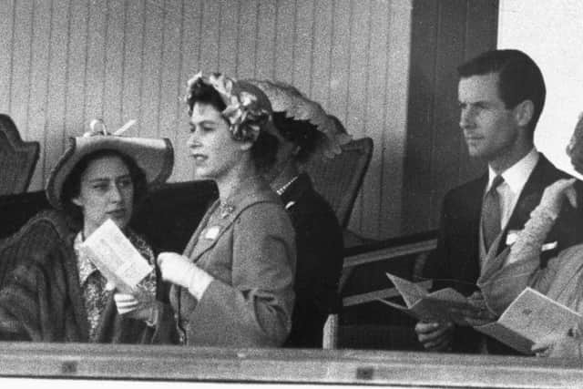 Princess Margaret (L), Princess Elizabeth and Group Captain Peter Townsend gather June 13, 1951 in the Royal Box at Ascot