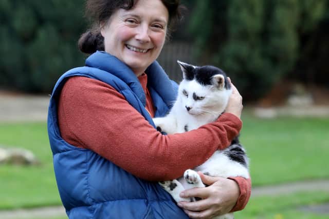 Tina Lewis with one of the more than 130 cats she cares for at Filey Cat Rescue in North Yorkshire.