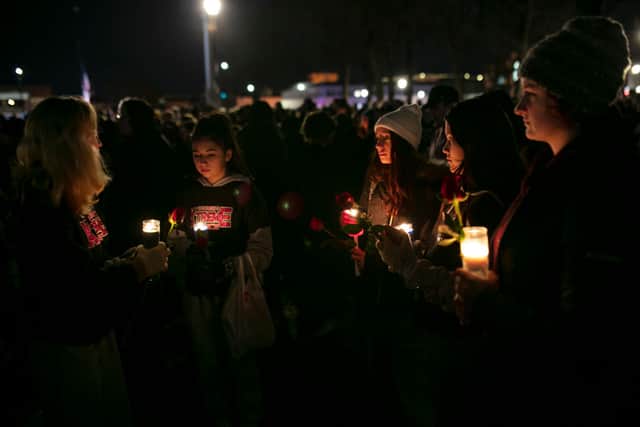 People hold candles during a vigil in Cutler Park in Waukesha, Wisconsin on 22 November 2021 (Photo: Jim Vondruska/Getty Images)