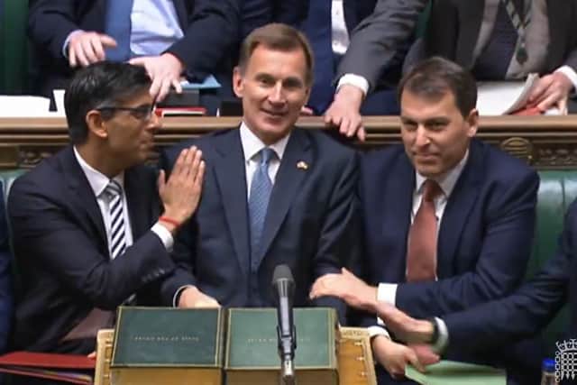 Prime Minister Rishi Sunak congratulates Chancellor of the Exchequer Jeremy Hunt after he delivered his autumn statement. Credit: PA