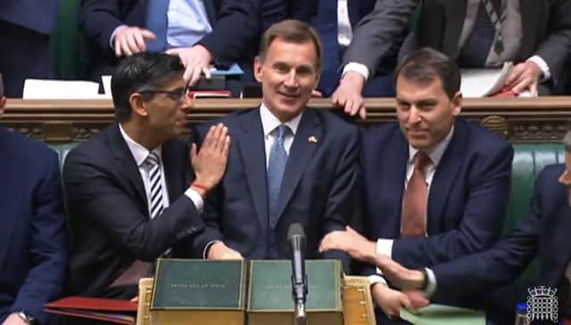 Prime Minister Rishi Sunak congratulates Chancellor of the Exchequer Jeremy Hunt after he delivered his autumn statement. Credit: PA