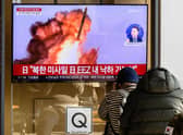 People sit near a television showing a news broadcast with file footage of a North Korean missile test, at a railway station in Seoul, South Korea.  Credit: ANTHONY WALLACE/AFP via Getty Images