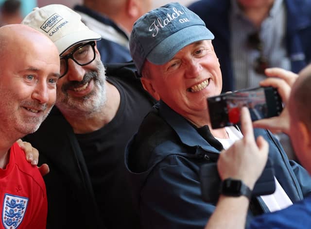English comedians Frank Skinner and David Baddiel  take a picture with a fan. (Getty Images)