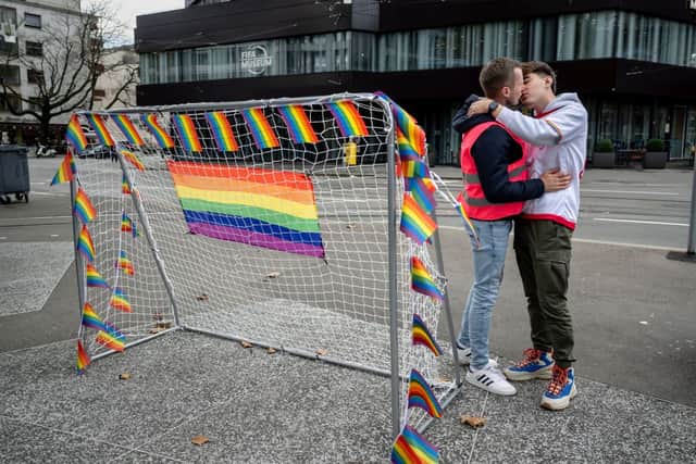 Two men kiss next to a football goal during a protest against Qatar’s treatment of the LGBTQ+ community. Credit: Getty Images