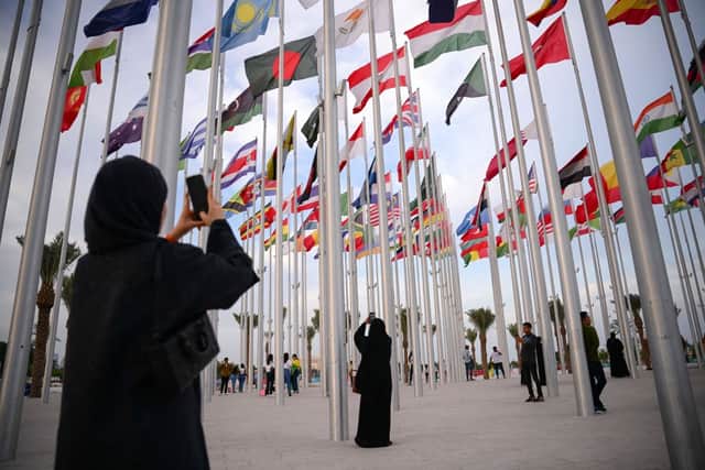 Women take photos at Flags Square, in Doha ahead of the Qatar 2022 World Cup. Credit: Getty Images