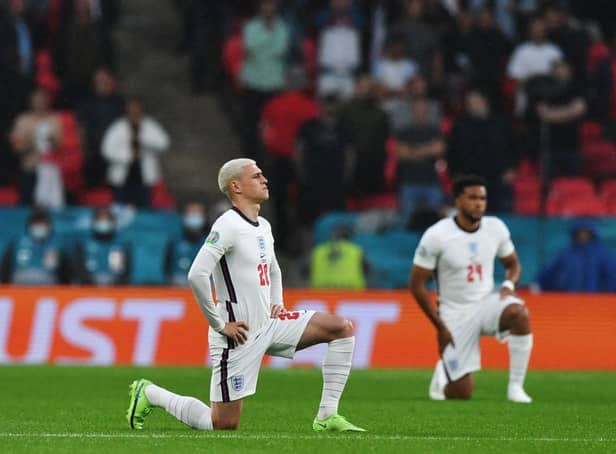 <p>Players kneel down against racism before the UEFA EURO 2020 Group D football match between England and Scotland at Wembley Stadium in London on June 18, 2021 (Photo: JUSTIN TALLIS/POOL/AFP via Getty Images)</p>