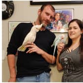 Pictured David Holt with cockatoo Pearl and his girlfriend Danyelle Stelly with Indian Ringneck Pippin. Pearl dances when David plays music and has gained thousands of followers on TikTok because of it.