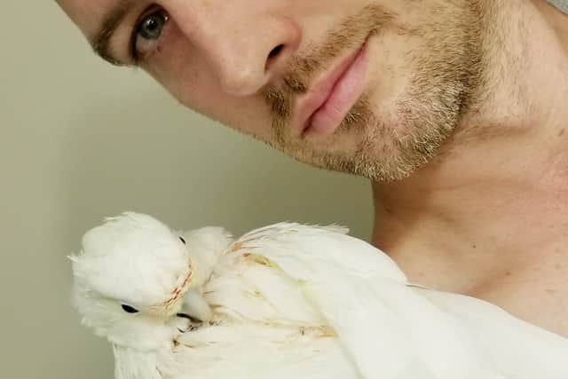 Pictured David Holt and cockatoo Pearl.