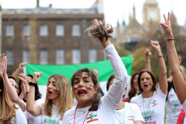British-Iranian women take part in a demonstration opposite the Houses of Parliament in central London on November 19, 2022, ahead of Iran's fixture against England in the 2022 FIFA World Cup. - The 22 women protestors are calling for people in Iran and around the world to protest at the start of every world cup match played by Iran, by blowing a football whistle for one minute at the start of each match. (Photo by ISABEL INFANTES / AFP) (Photo by ISABEL INFANTES/AFP via Getty Images)