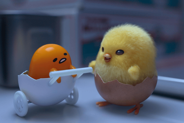 Shakipiyo, an anthropomorphic egg yolk in an eggshell pram, and Gudetama, a chick wearing an eggshell as trousers, in Gudetama: An Eggcellent Adventure (Credit: Netflix)