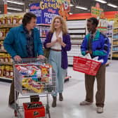 Adam Driver as Jack, Greta Gerwig as Babette, and Don Cheadle as Murray in White Noise, pushing a shopping trolley round a supermarket (Credit: Wilson Webb/Netflix)