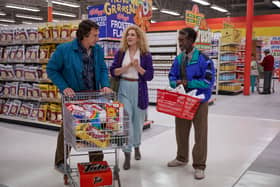 Adam Driver as Jack, Greta Gerwig as Babette, and Don Cheadle as Murray in White Noise, pushing a shopping trolley round a supermarket (Credit: Wilson Webb/Netflix)