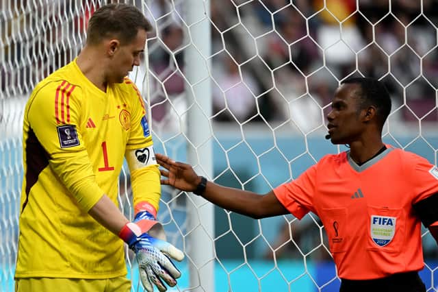 Neuer has his armband checked by assistant referee